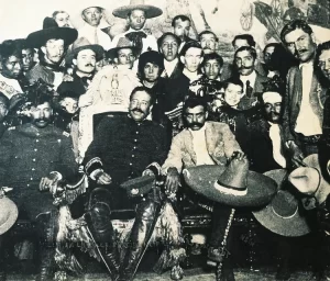 pancho-villa-on-presidential-chair-during-revolution-of-1914-in-national-palace-in-mexico-city--zapata-is-at-left--mexico--20th-century-153415896-59ef75efc412440011bfd3af
