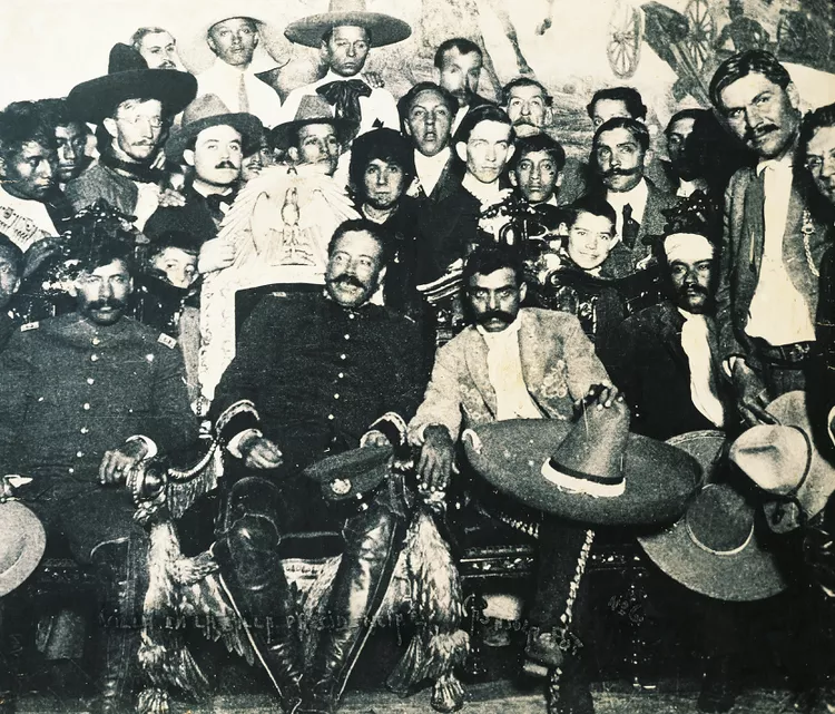 pancho-villa-on-presidential-chair-during-revolution-of-1914-in-national-palace-in-mexico-city--zapata-is-at-left--mexico--20th-century-153415896-59ef75efc412440011bfd3af